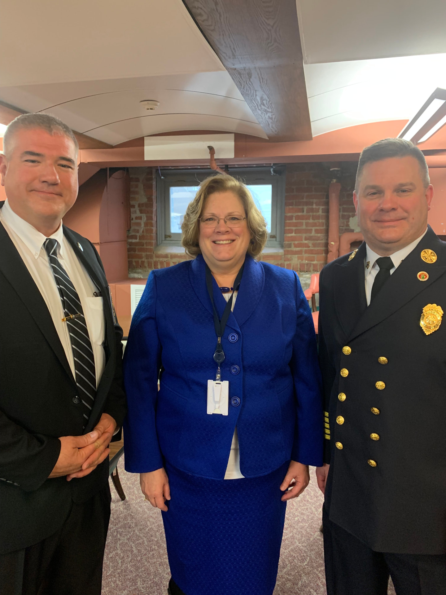 Sharon Carson with a police officer and a fire chief