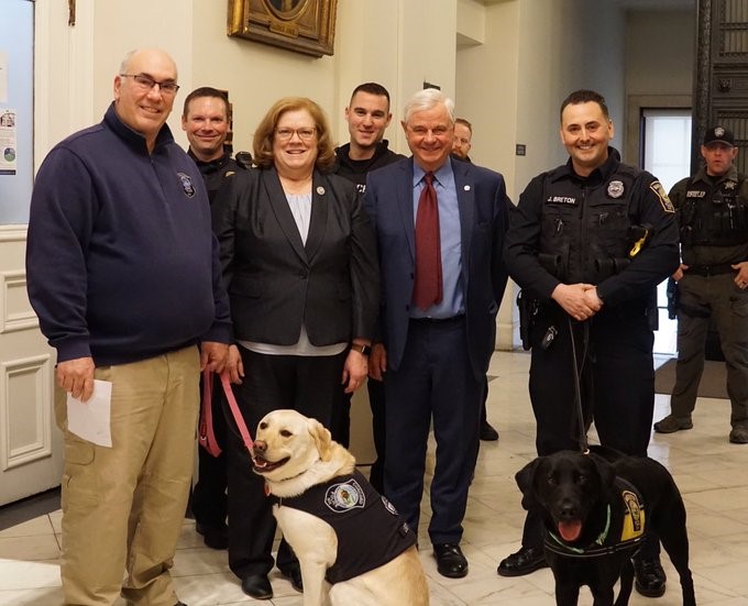 Sharon Carson with police officers and their K-9 partners